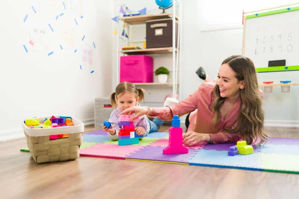 Therapist and Little Girl Playing with Building Blocks
