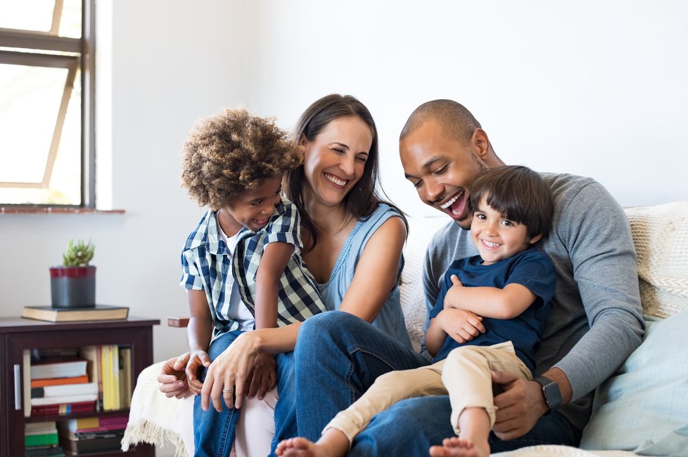 Mother And Father Playing & Laughing With Two Kids