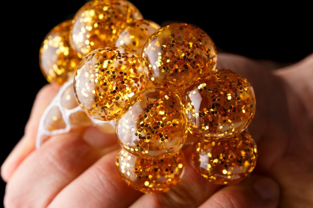 Toddler With Autism Squeezing A Golden Gel Stress Ball