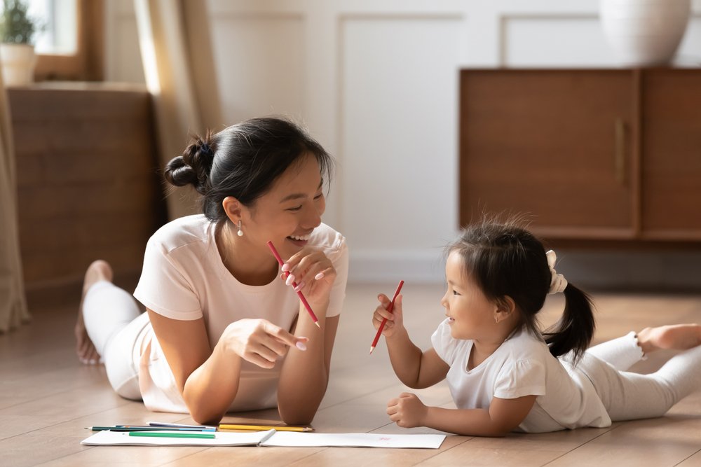 A Mom Playing With Her Daughter On The Floor