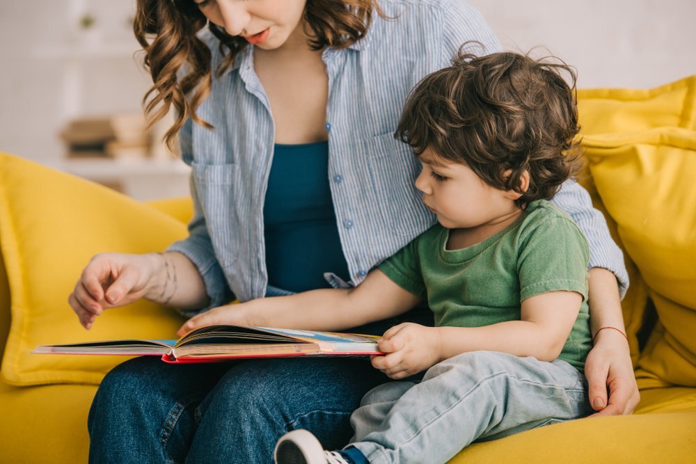Mother Reading A Book To Her Autistic Toddler