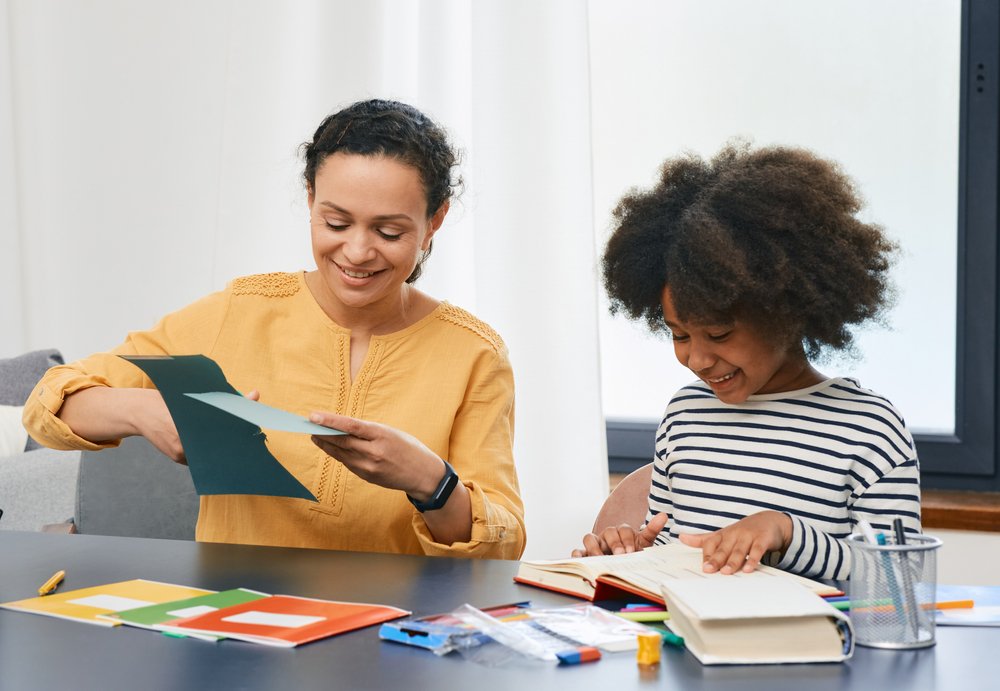 ABA Therapist Doing Paper Crafts With Girl In A Session