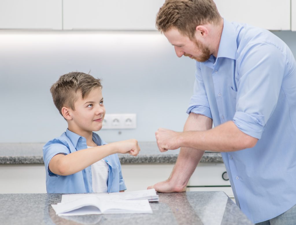 Dad Using a Fist Pump as Positive Reinforcement to Signify “A Job Well Done” to Son