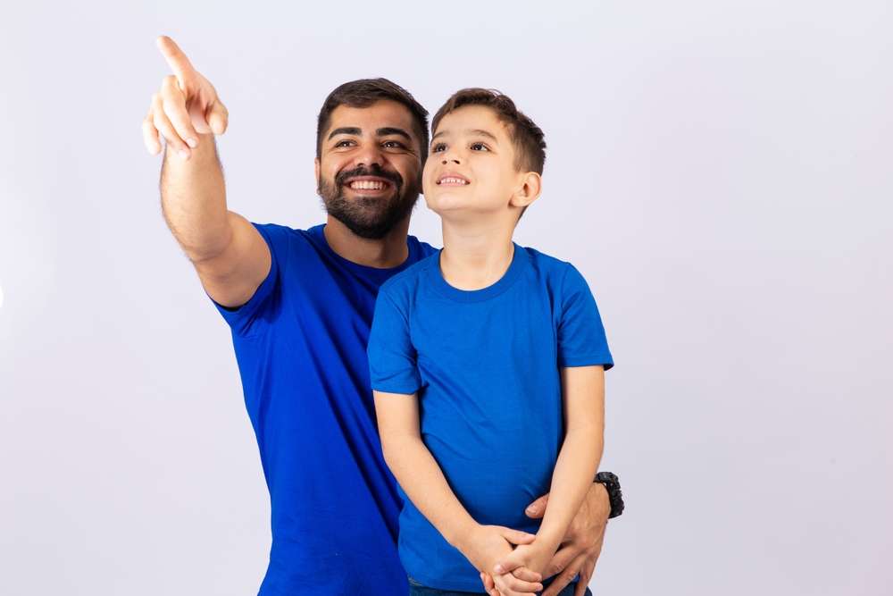 Father pointing at something with his son