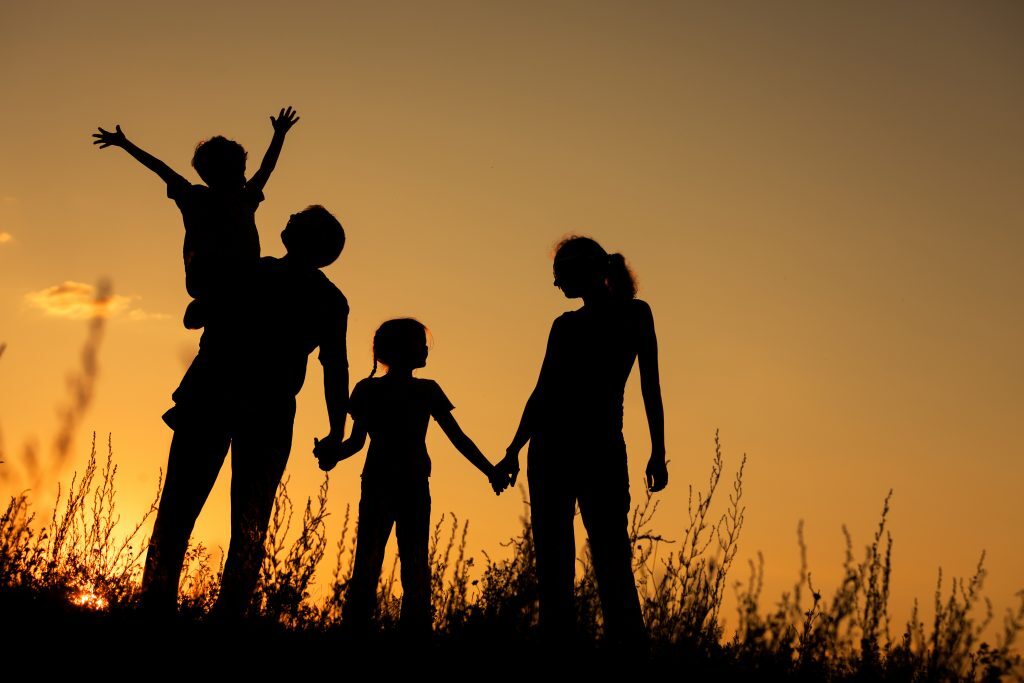 Silhouette Of A Family Having Fun Outside