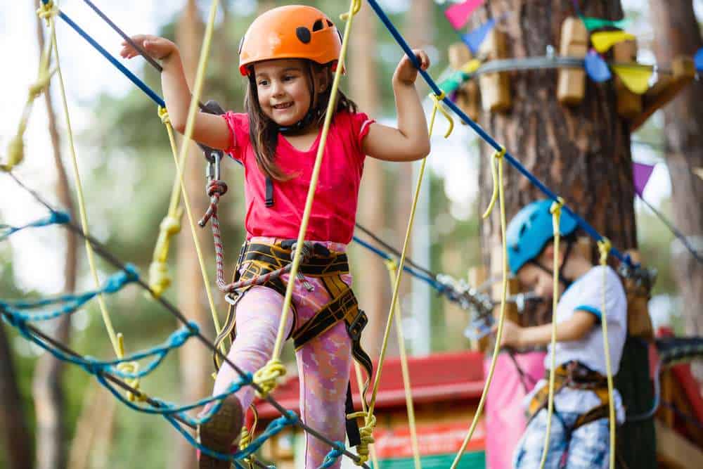 Young girl having fun on an outdoor ropes course